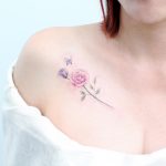 Pink rose tattoo on shoulder