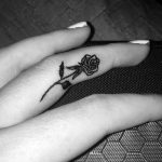 Small rose tattoo on finger